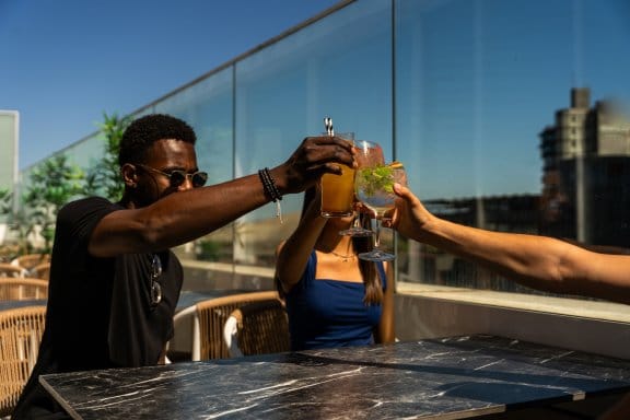 Group of people toasting on a rooftop