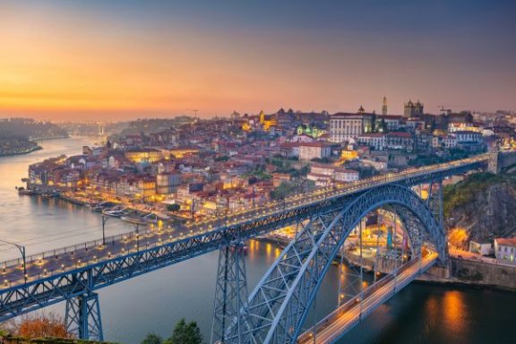 Porto's skyline at dusk, city lights and the Douro river