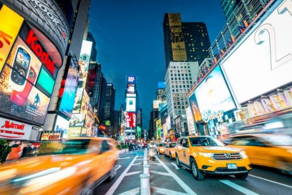 New York Times Square at dusk, a rush of taxis