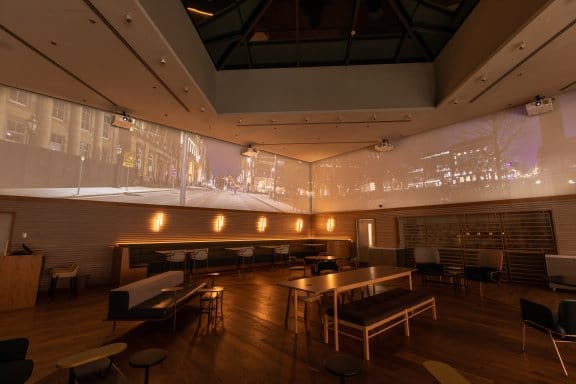 A romantically lit event space with a 360 degree screen
