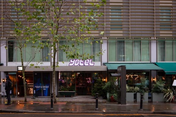 The outside of a modern hotel in a busy Manchester street