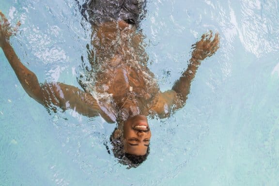 A man relaxes in a swimming pool