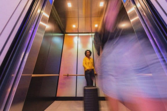 A woman laughs as she takes the elevator