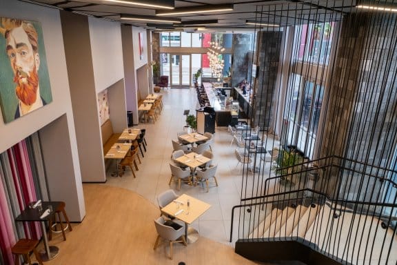 An overhead view of a modern restaurant with large floor-to-ceiling windows