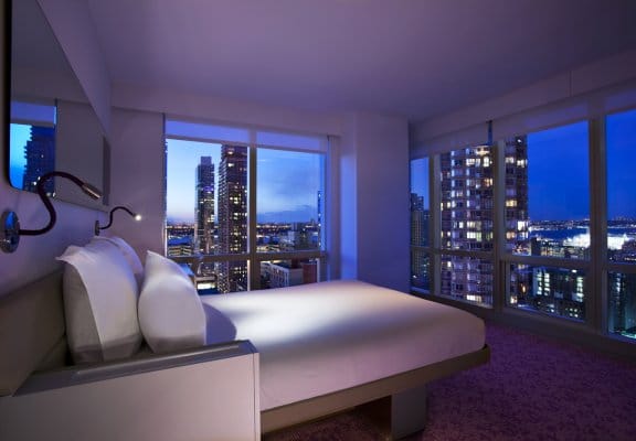 A high-rise hotel room with panoramic views of New York