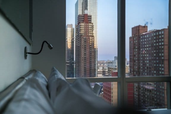 An atmospheric hotel room with sweeping views of New York City
