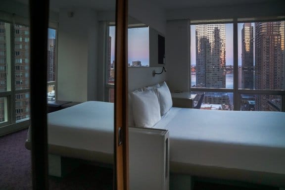 An atmospheric hotel room with sweeping views of New York City