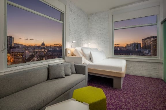 A clean hotel room with a panoramic view of san francisco