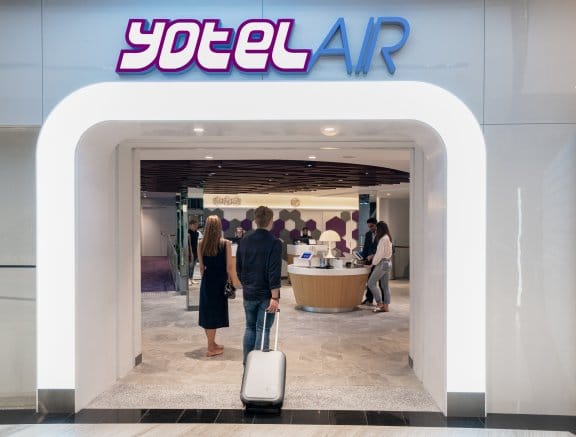 A man walks into the entrance of YOTELAIR