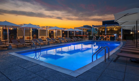 A serene rooftop pool seen at night