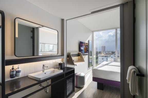 Hotel bedroom with basin, mirror and beds