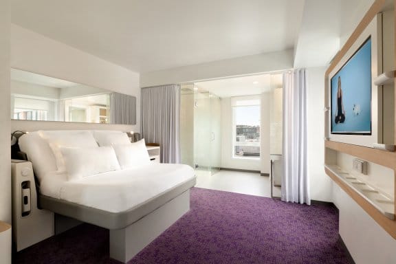 A large hotel room with a flatscreen TV