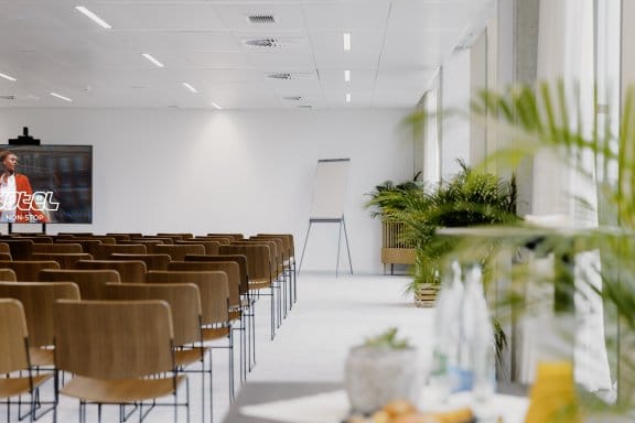 A bright and leafy auditorium with a flatscreen television