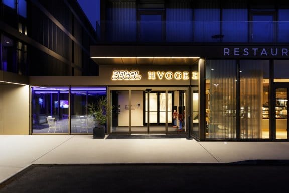 A modern hotel and restaurant entrance with neon lights
