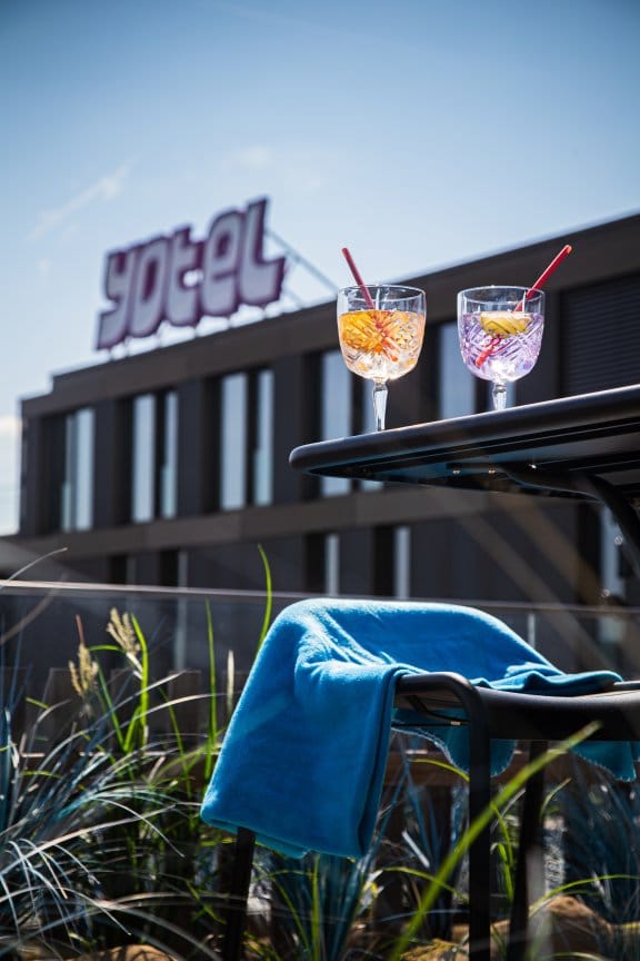 Two cocktails in an outdoor eating area