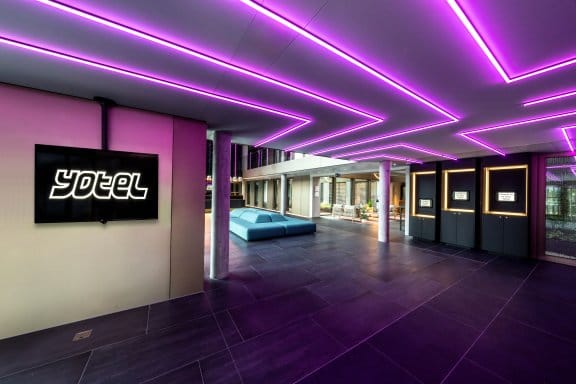 A modern hotel reception with purple lights