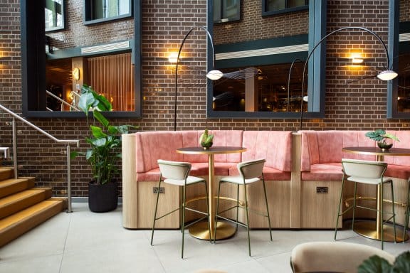 A trendy cafe or bar with pink cushions 