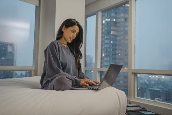 A girl on her laptop in her hotel room