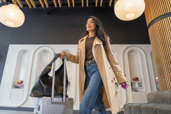 A woman walks through a hotel lobby