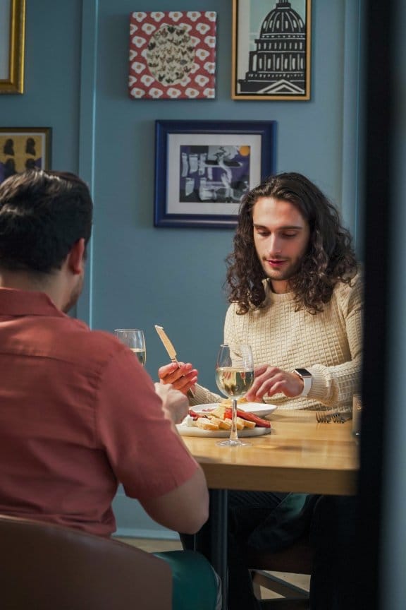 Friends enjoy a meal in an artsy restaurant