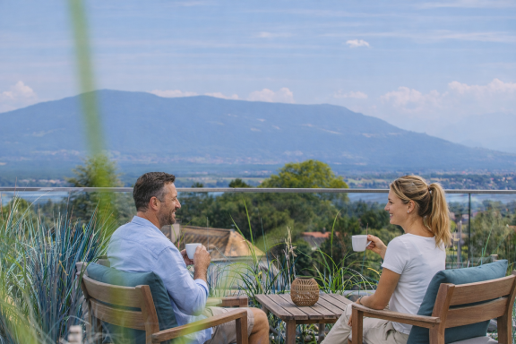 A couple share coffee with mountain views