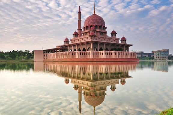 Sky reflecting on the water with a temple in Kuala Lumpur