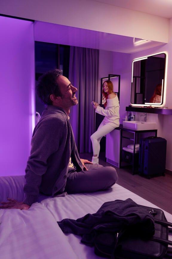 A couple unpack in their hotel room