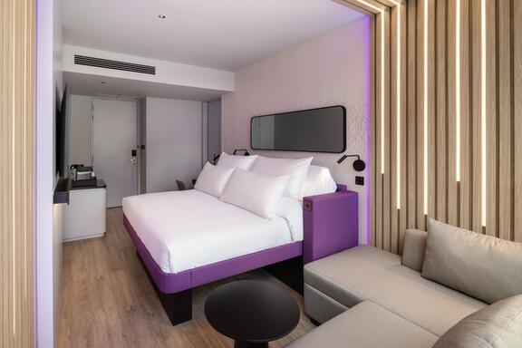 King size bed with sofa in foreground