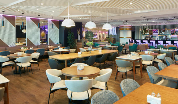 Multiple tables set up in Komyuniti Restaurant inside YOTEL Istanbul Landside