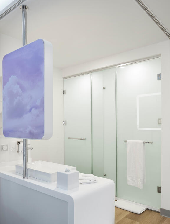 YOTEL Istanbul Airside hotel room with shower cubicle, toilet and vanity area with sink