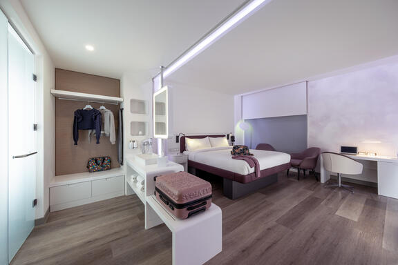 YOTEL Istanbul Landside First Class junior suite with plenty of storage space and work desk