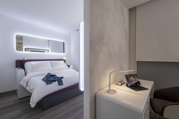 YOTEL Istanbul Airside premium room with work desk separated with wall from main bedroom