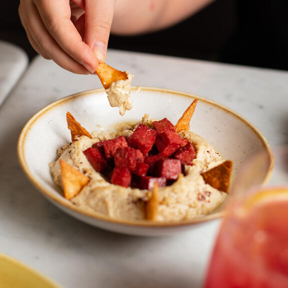 Delicious bowl of humous and tortillas, a popular dish in YOTEL Istanbul Landside restaurant