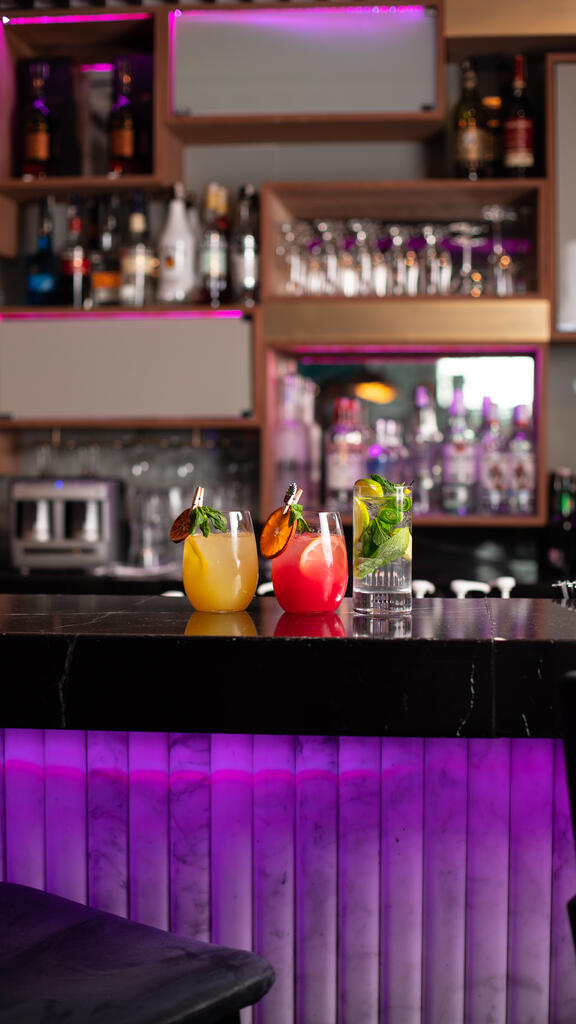 Close up of Komyuniti Bar with fruity cocktails in YOTEL Istanbul Landside