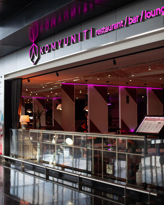 Outside shot of Komyuniti Bar and Restaurant with signage