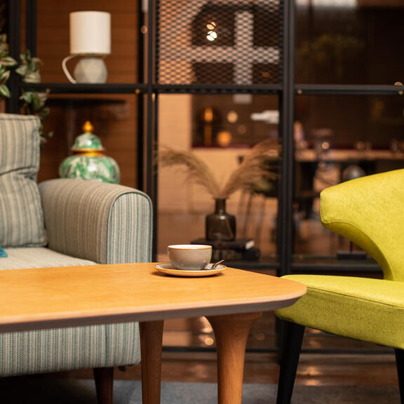 Close up of comfortable sofas and table with coffee at Komyuniti in YOTEL Istanbul Landside