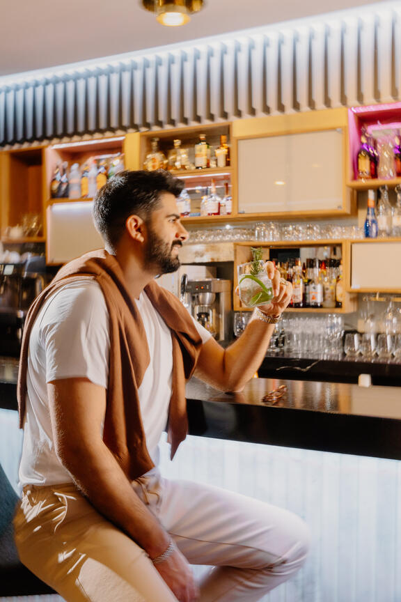 Man enjoys drink at the Komyuniti Bar at YOTEL Istanbul Landside