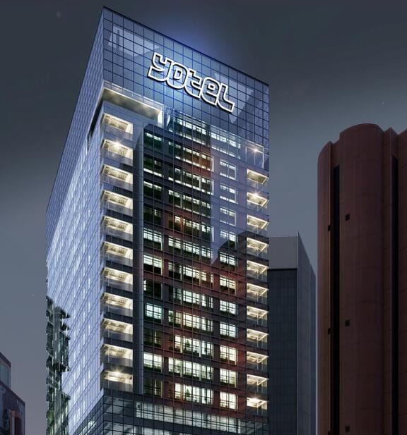 YOTEL is written on a super-modern glass building at night