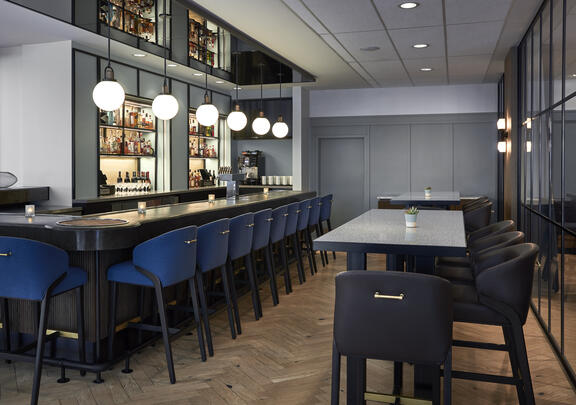YOTEL Washington DC Art and Soul bar area with modern lighting and large comfortable bar seating