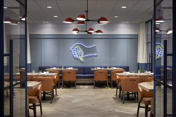 YOTEL Washington DC Art and Soul restaurant shows multiple tables set up in large open space