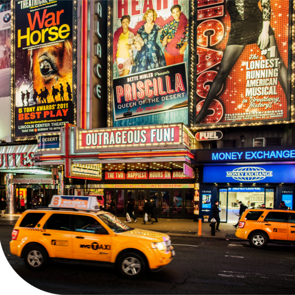 Taxis driving by broadway theatre shows