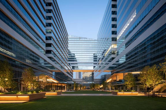 A shiny glass building at dusk