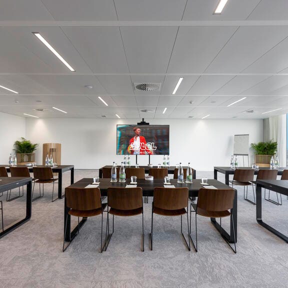 A large airy meeting space with a flatscreen TV