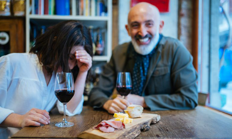 Two people drinking wine and eating cheese in a cafe in Istanbul
