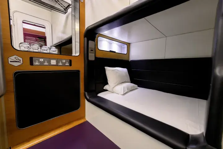 Compact room with bed, storage, plugs, tea and coffee facilities and a flatscreen TV