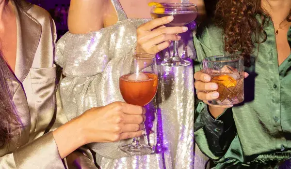 Three girls drinking cocktails