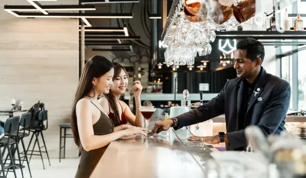 PEOPLE AT BAR GETTING A DRINK