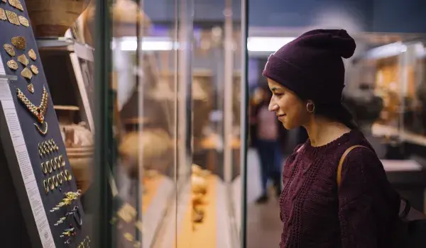 A lady viewing an artifact at a museum