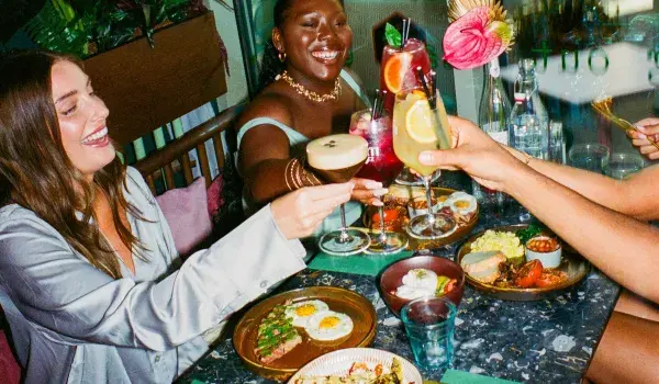 People toasting with breakfast foods