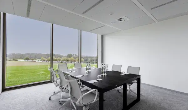 Meeting room with board room table in middle